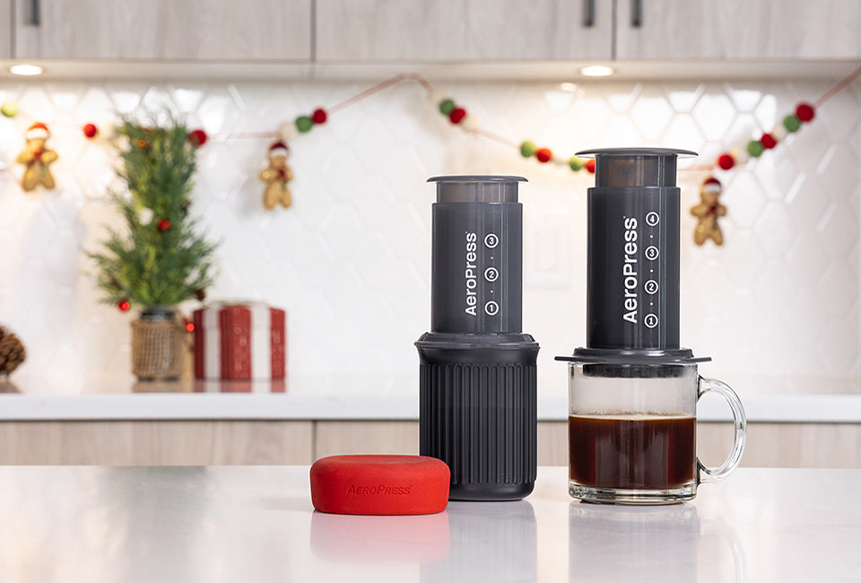 AeroPress Original and AeroPress Go by holiday decorations on kitchen counter