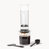 AeroPress Clear XL coffee maker with a white background