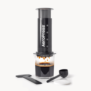 AeroPress XL coffee maker with a carafe of brewed coffee on a white background