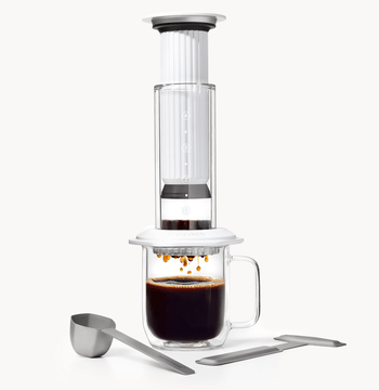 AeroPress Premium coffee maker with glass mug and scoop on a white background #color_white