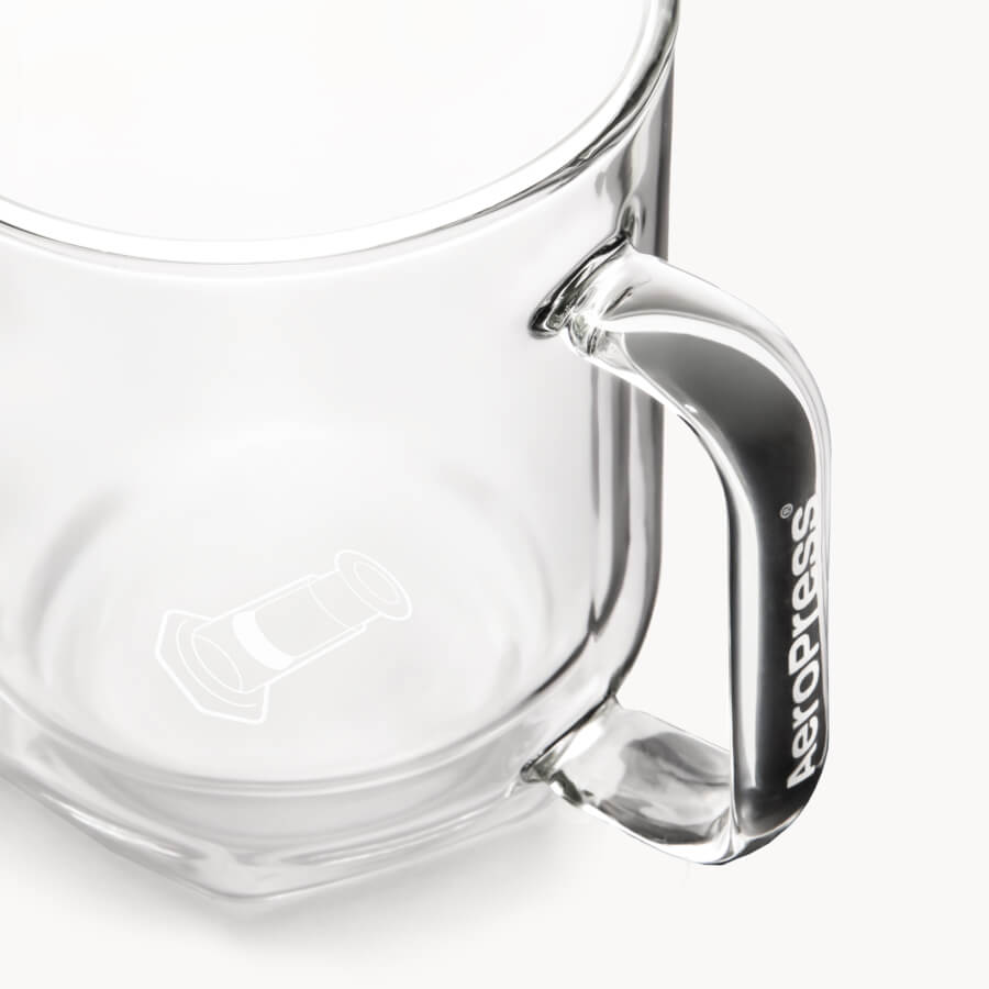 Clear glass mug with handle on a white background