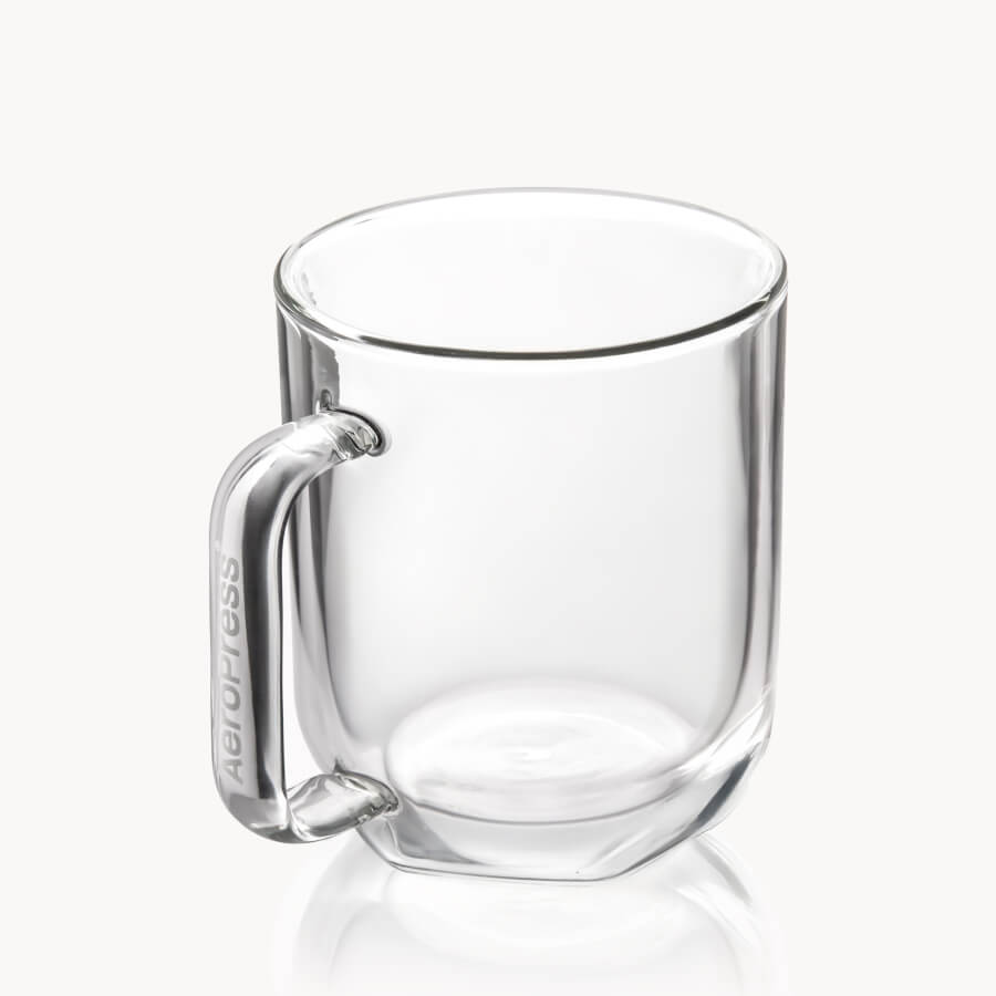Clear glass mug with handle on a white background