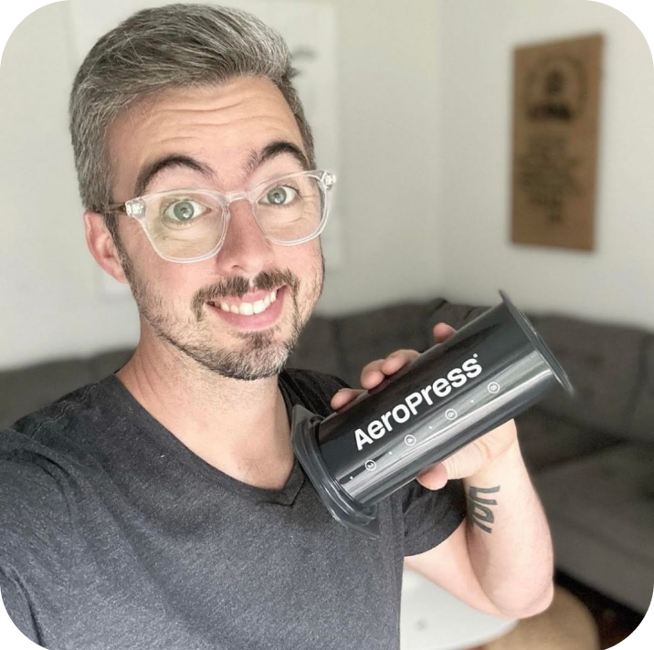 Man in glasses holding AeroPress XL