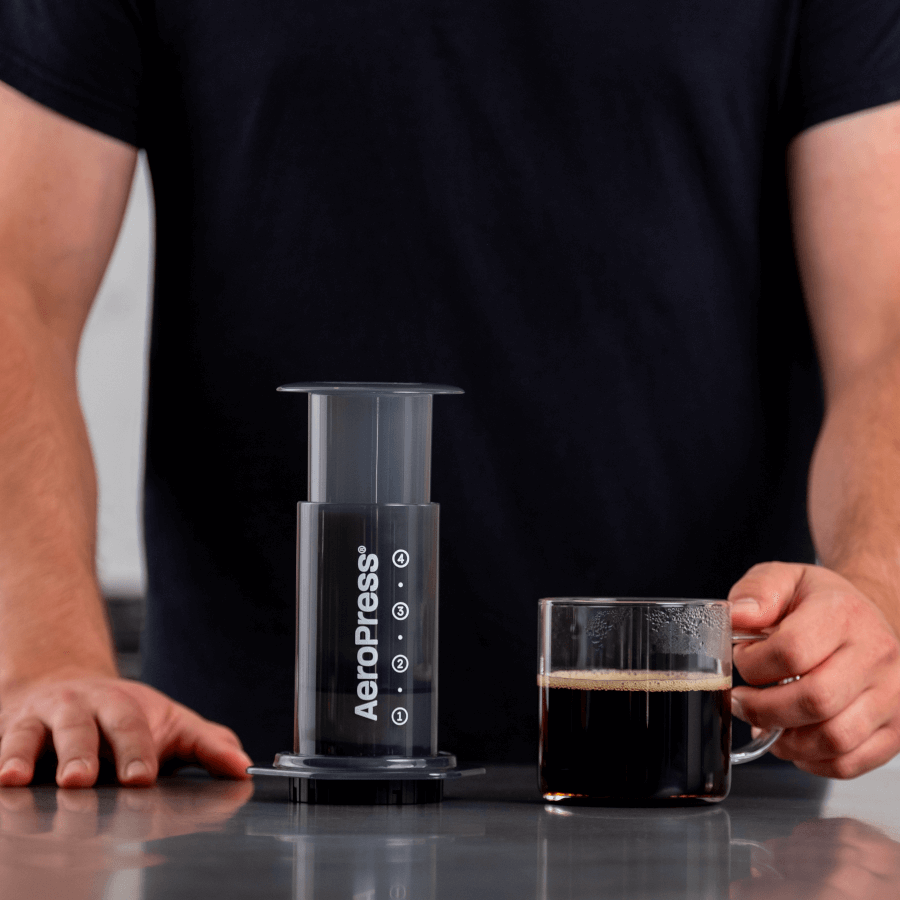 AeroPress Original Coffee Maker next to mug of coffee