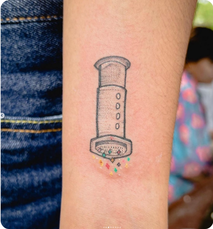 AeroPress tattoo pressing rainbow sparkles