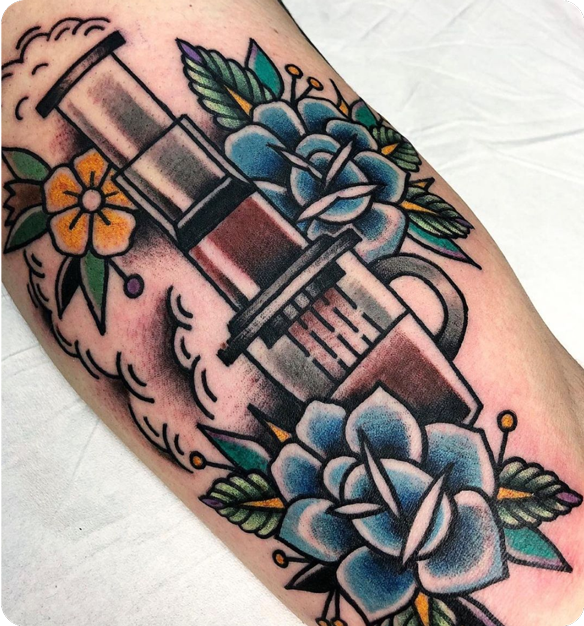 AeroPress tattoo with blue and yellow flowers