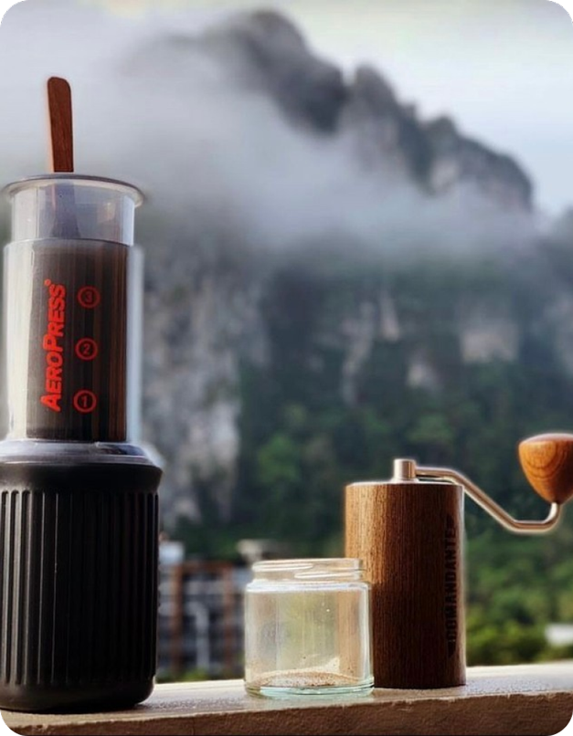 AeroPress Go with mountains and mist in background