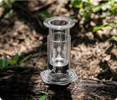 AeroPress Clear sitting on log