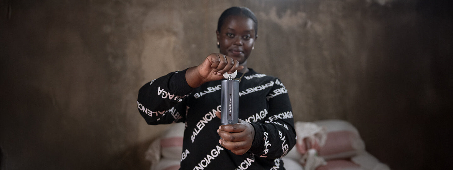 Woman using a manual coffee grinder