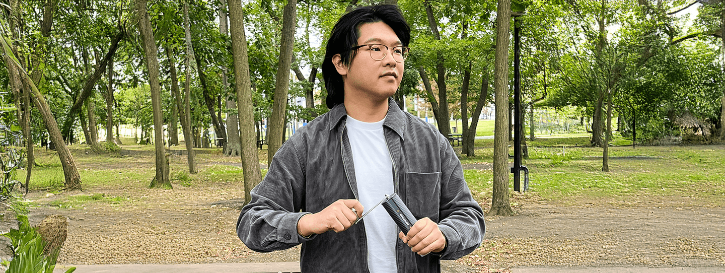 Brandon Lee using AeroPress Manual Grinder in a forest