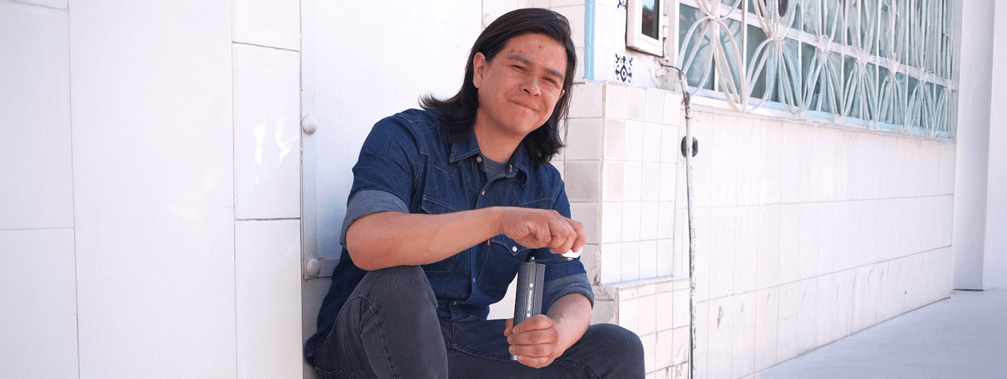 Carlos de la Torre grinding coffee with AeroPress Manual Grinder
