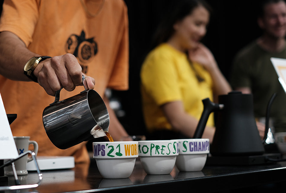 Pouring coffee into cupping bowls at 2021 World AeroPress Championship
