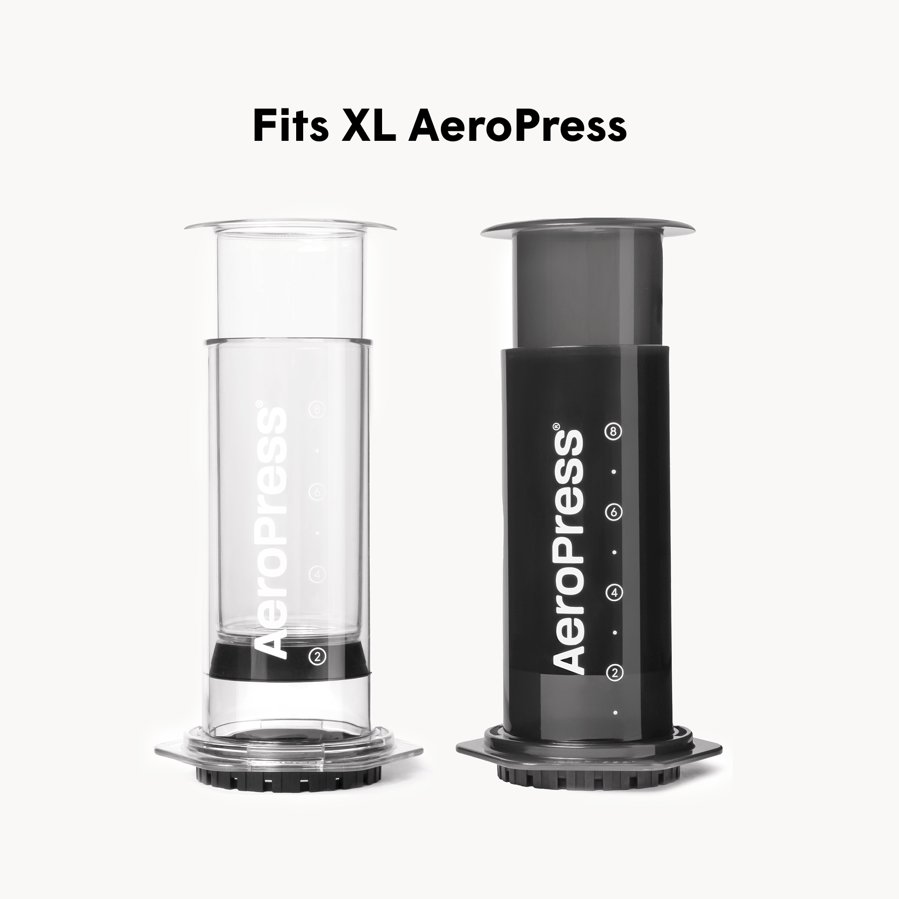Two AeroPress XL coffee brewing devices, one clear and one black, on a white background.