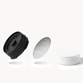 AeroPress Flow Control Cap, Stainless Steel Filter and paper micro-filters on a white background