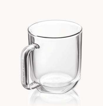 Clear glass mug with handle on a white background