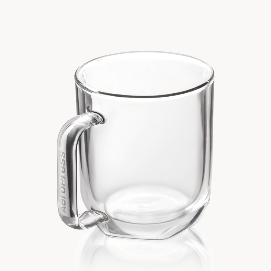 Clear glass mug with handle on a white background