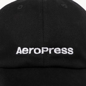 Up close view of black cap with AeroPress logo #color_black