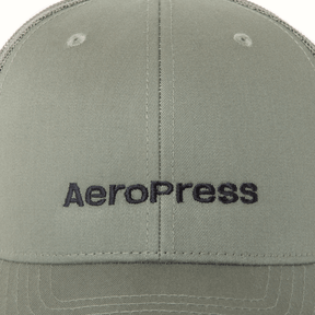 Green cap with AeroPress logo on a close-up view #color_green