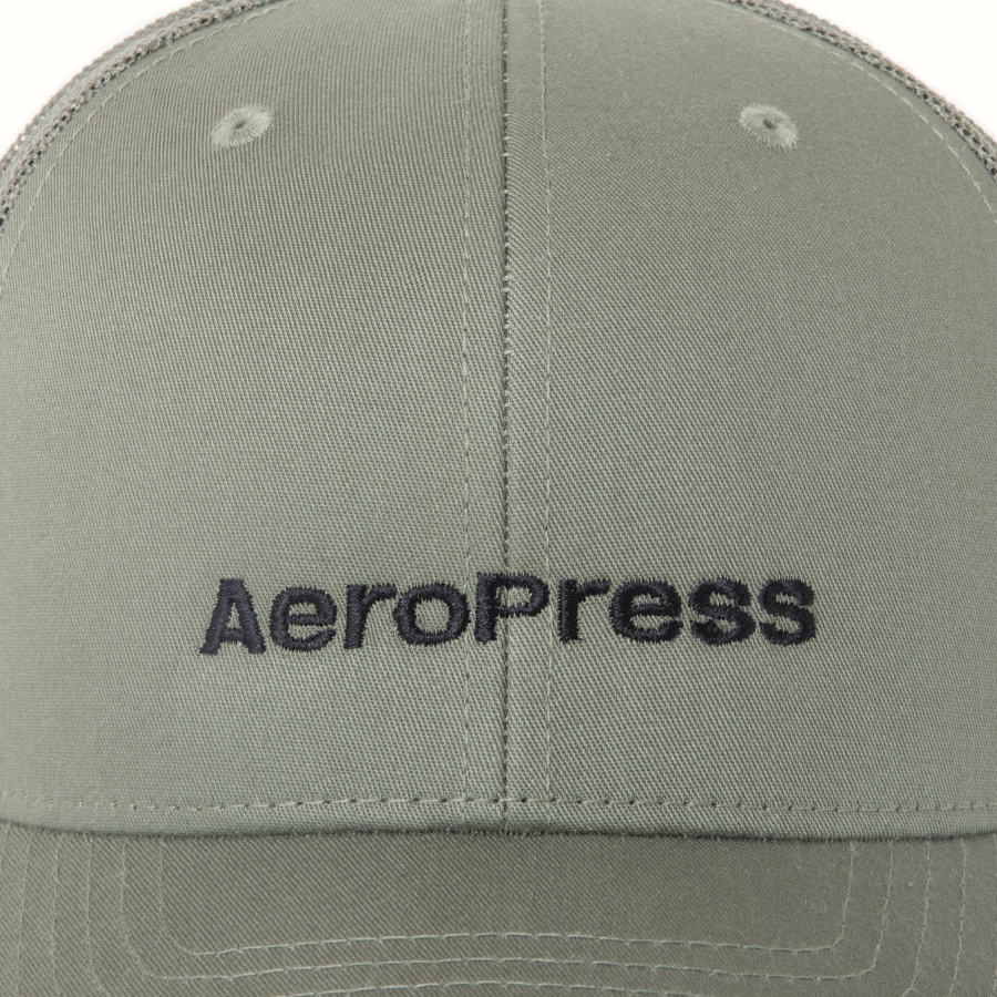 Green cap with AeroPress logo on a close-up view #color_green
