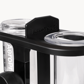 AeroPress coffee maker with clear plastic components on a white background