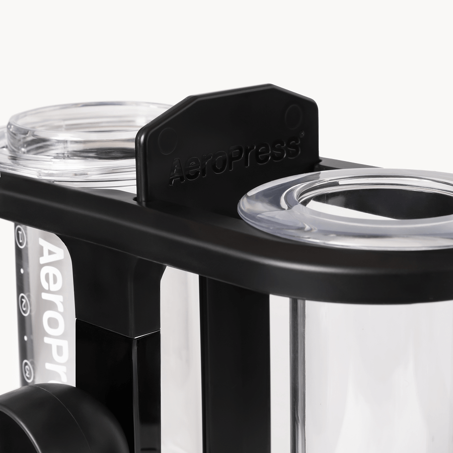 AeroPress coffee maker with clear plastic components on a white background
