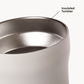 Black insulated tumbler with metallic interior on a white background #color_cream