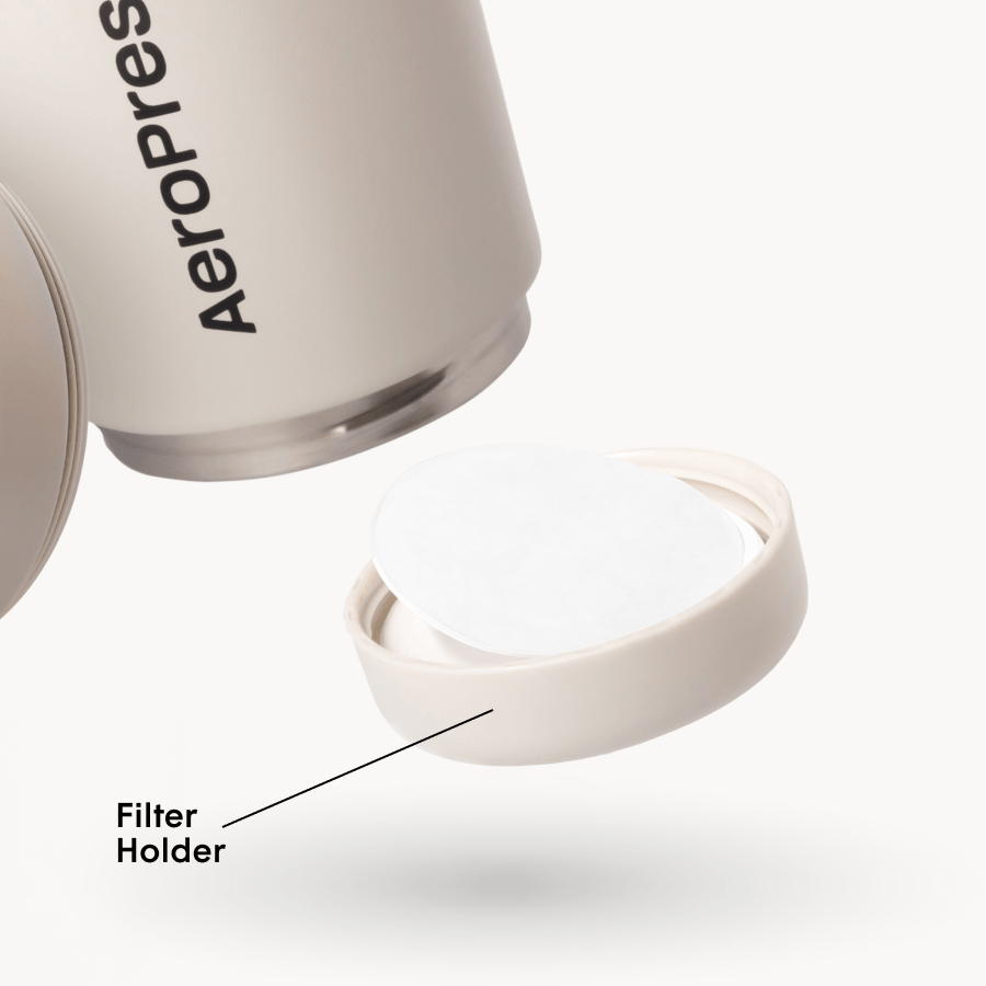 AeroPress tumbler with open filter holder on a white background #color_cream