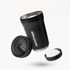 Black AeroPress tumbler with components on a white background #color_black