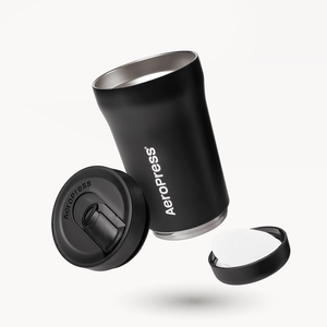 Black AeroPress tumbler with components on a white background 