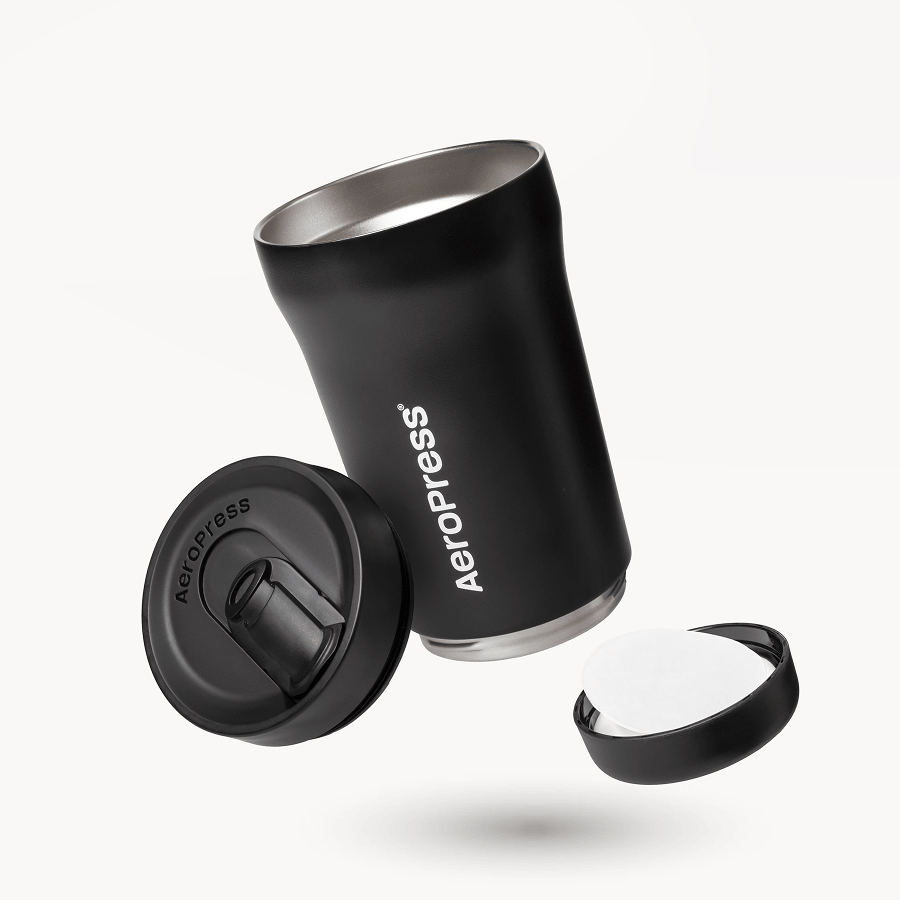 Black AeroPress tumbler with components on a white background #color_black