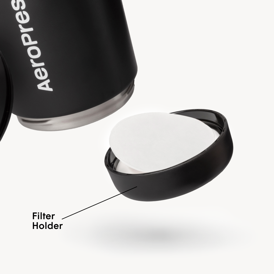 AeroPress tumbler with open filter holder on a white background #color_black
