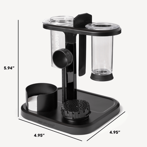 Black and clear coffee brewing device with measurements on a white background