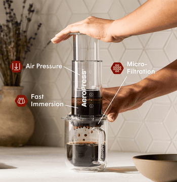 AeroPress Coffee Maker - Clear on glass coffee mug #color_clear