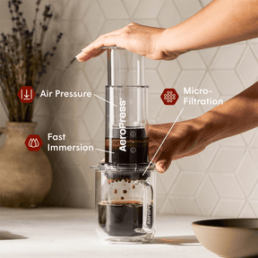 AeroPress Coffee Maker - Clear on glass coffee mug #color_clear