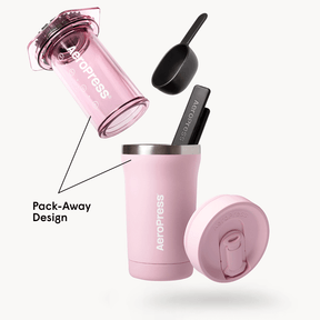 Pink AeroPress Go Plus coffee maker with components on a white background #color_pink