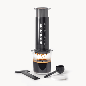 AeroPress XL coffee maker with a carafe of brewed coffee on a white background
