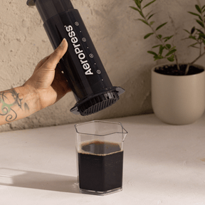 AeroPress XL coffee maker with coffee in a carafe