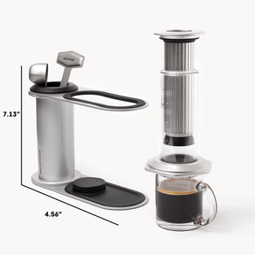 Aeropress coffee maker with a glass of coffee on a white background #color_silver