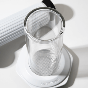 Clear AeroPress Premium chamber and plunger with  a white background #color_white