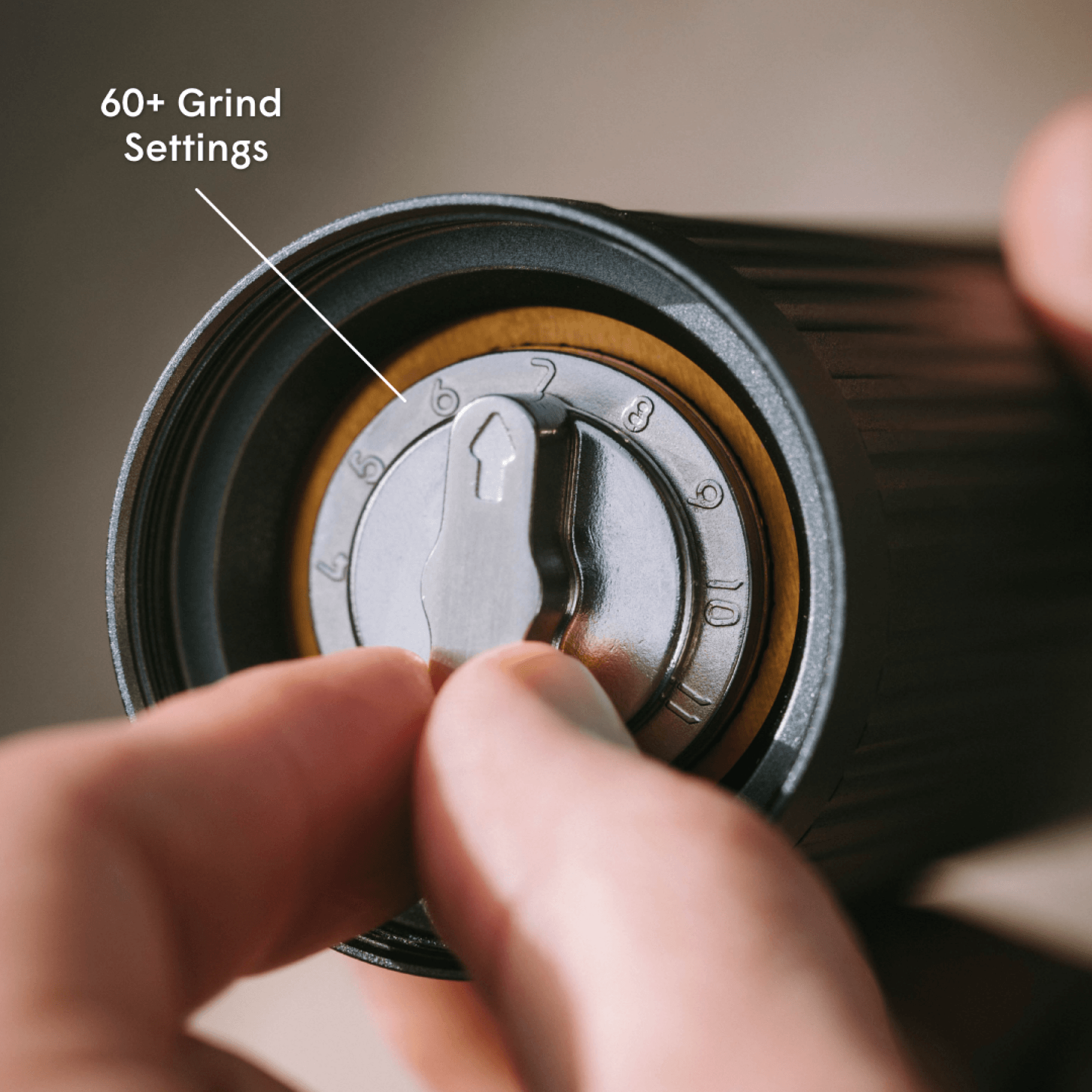 Hand adjusting a AeroPress coffee grinder with '60+ Grind Settings' #color_Purple