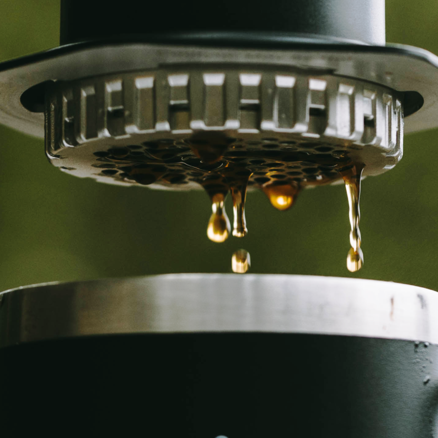 Close-up of a coffee filter with coffee dripping through. #color_black
