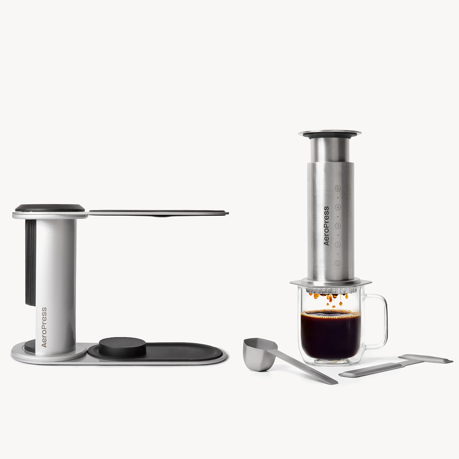 Aeropress coffee maker with a glass of coffee on a white background #color_silver