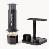 Aeropress coffee maker with a stand on a white background