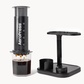 Aeropress coffee maker with a stand on a white background