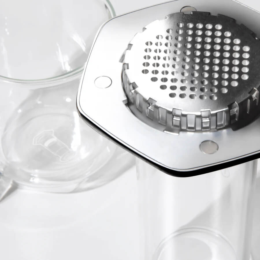 Silver AeroPress Premium coffee maker on a black background #color_black