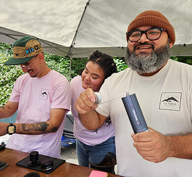 Three people in an outdoor tent