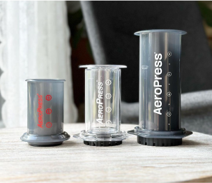 AeroPress Go, Clear, and XL next to each other on table