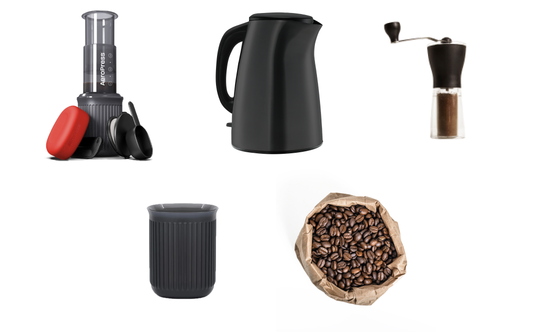 AeroPress Go next to kettle, hand grinder, Go mug and bag of coffee beans