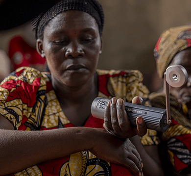 Woman holding a manual grinder with a blurred background