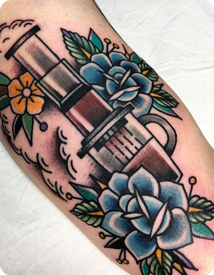 AeroPress tattoo with blue and yellow flowers